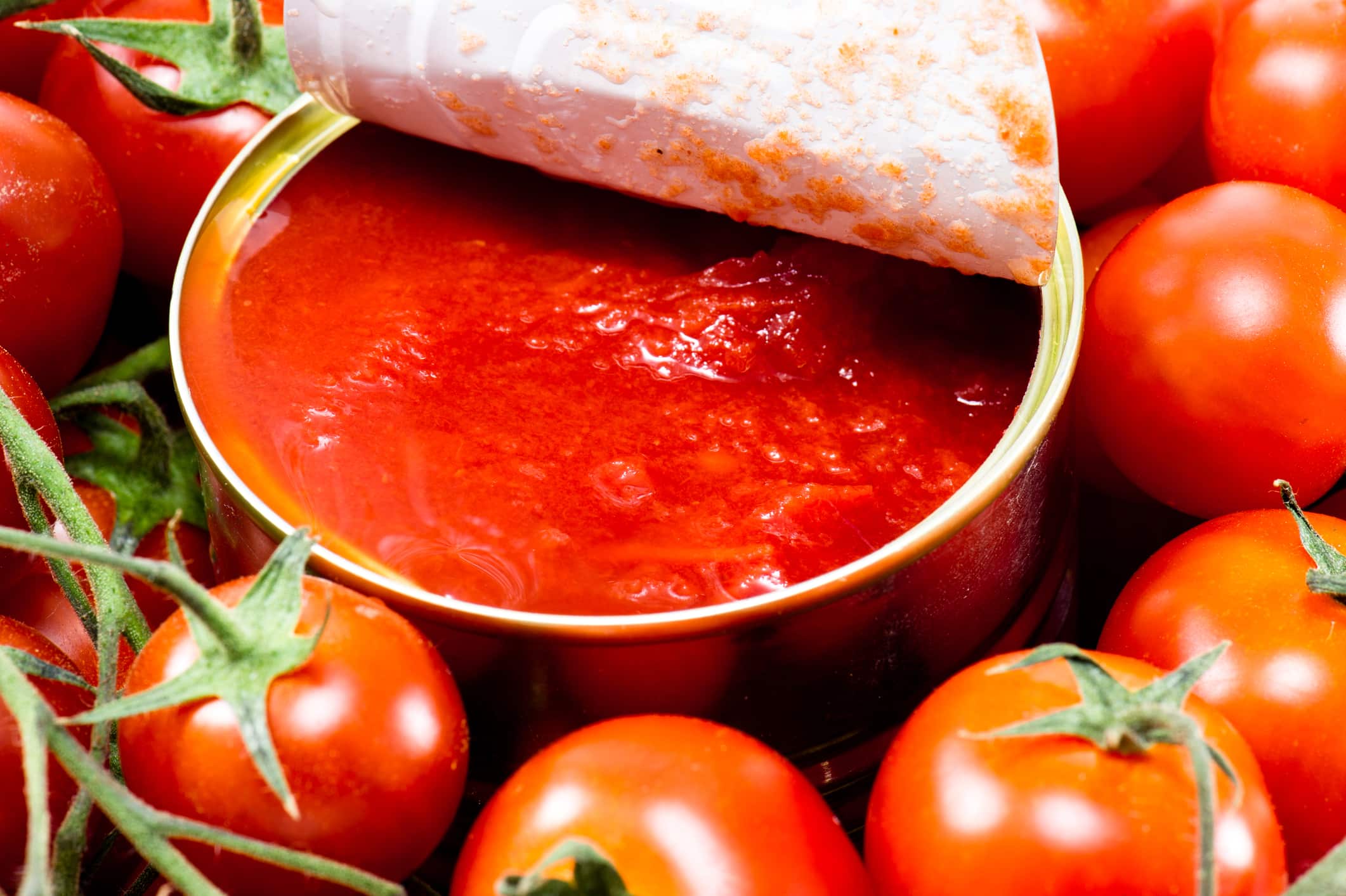 Immagine di una bottiglia di passata di pomodoro con un'etichetta evidenziata per i potenziali effetti negativi.